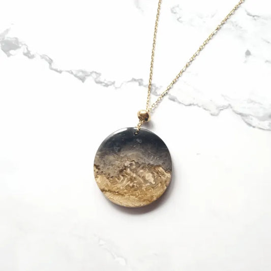 pendentif palmier fossil dore rond MystikBox